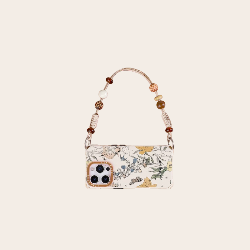 cute beige floral phone case with beaded strap – handbag flatlay
