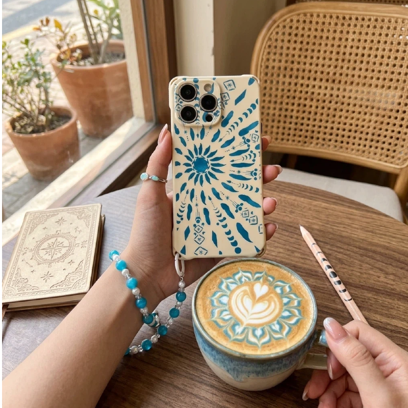 A woman in beige yoga wear holding a MatCase sand-colored phone case with a beaded crossbody lanyard, showcasing a minimalist fitness aesthetic.